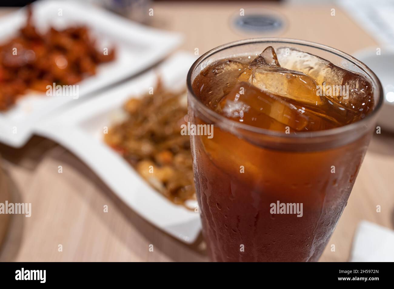 Iced tea with Chinese food at Restaurant Stock Photo