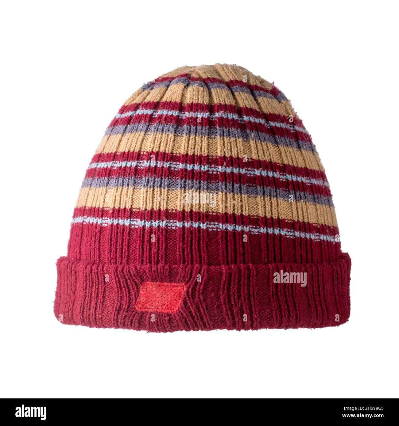 colorful winter cap isolated on white background, closeup of maroon and beige color woolen beanie for cold weather Stock Photo