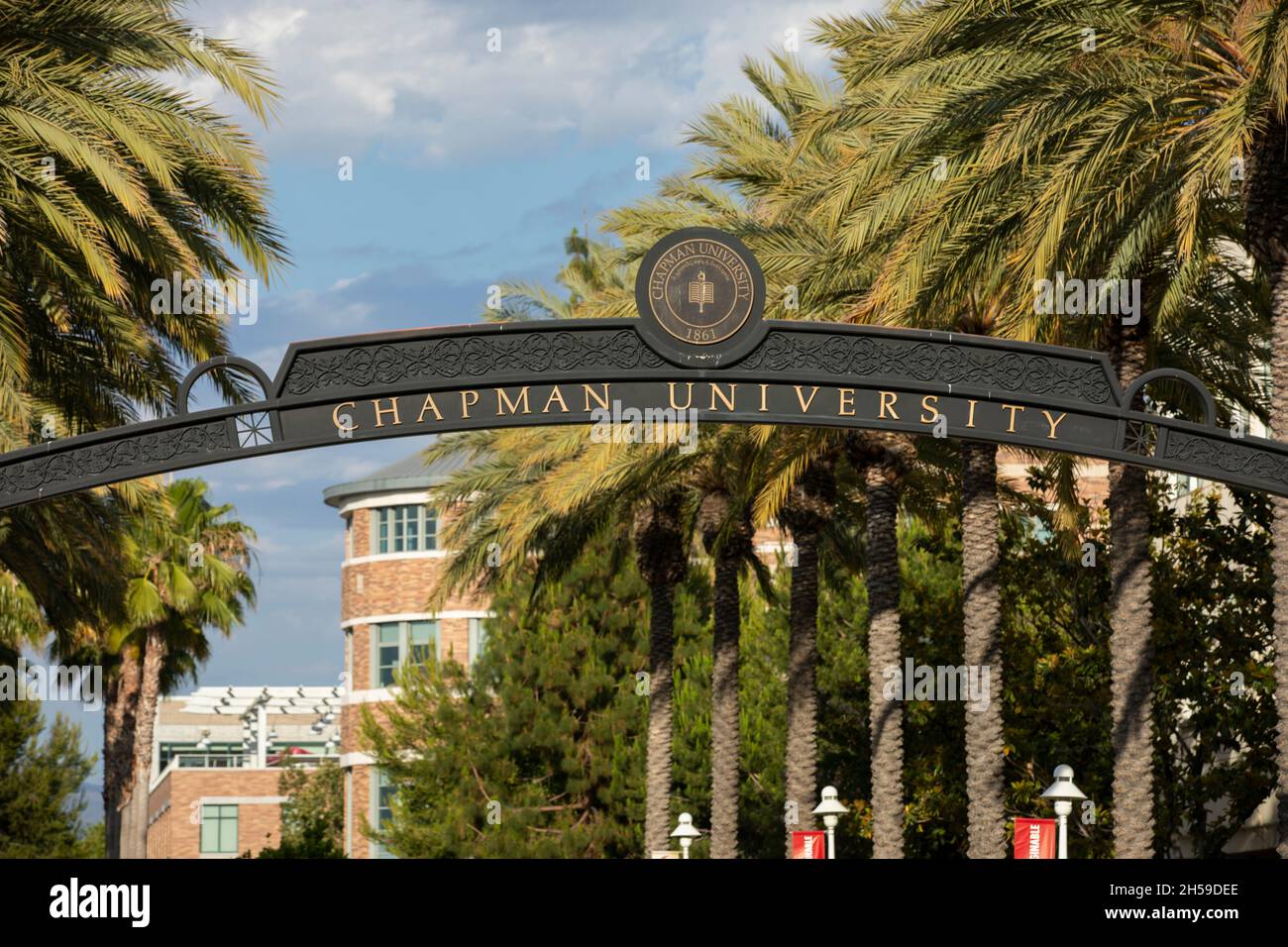 Orange, California, USA - June 23, 2021: Sun shines on a sign at the entrance of Chapman University. Stock Photo