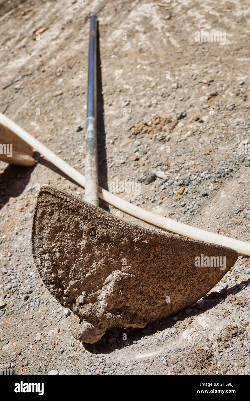 Close up of a used old metal shovel on the ground on a sunny day Stock Photo Alamy