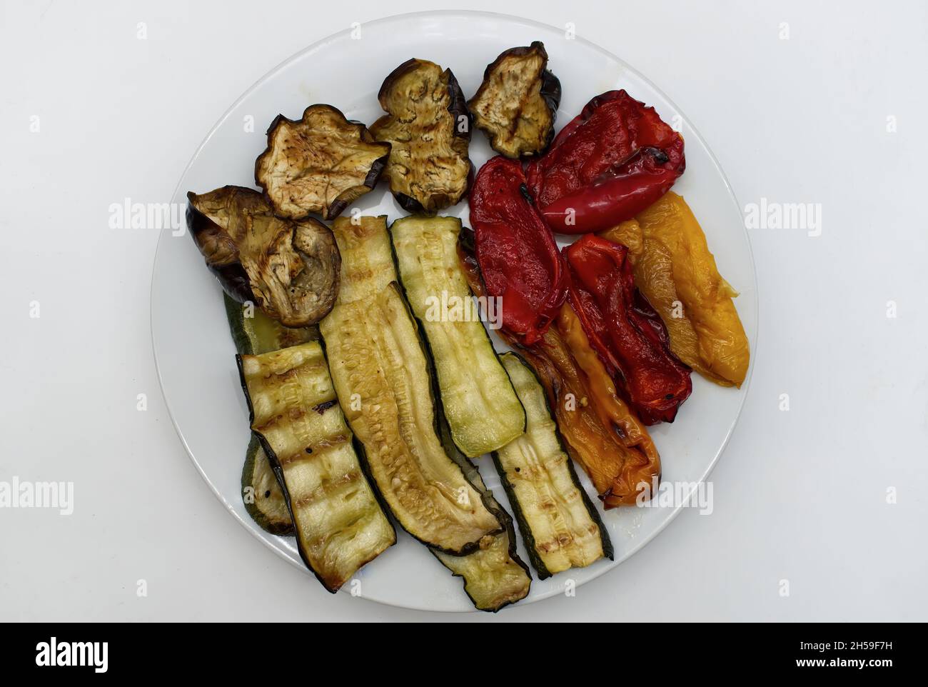 Grilled mix vegetables in a dish isolated on white background. View from above Stock Photo