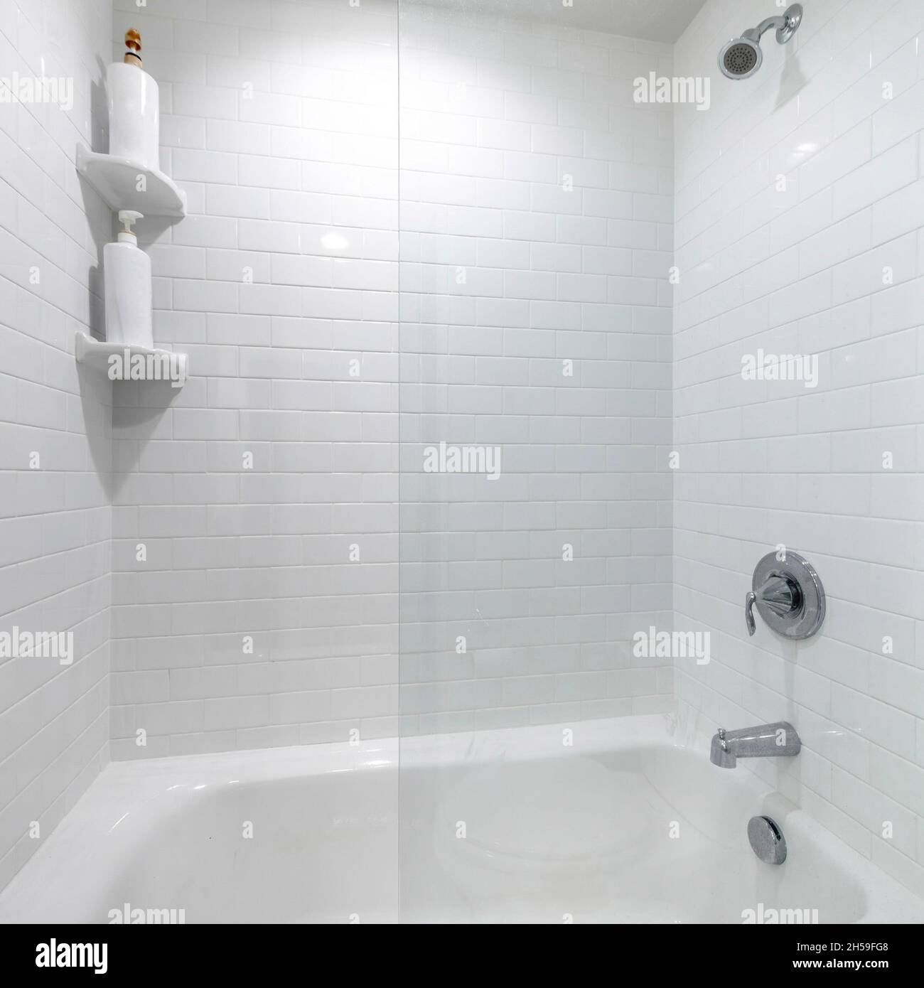 Square frame Alcove bathtub with glass wall divider and a wall with