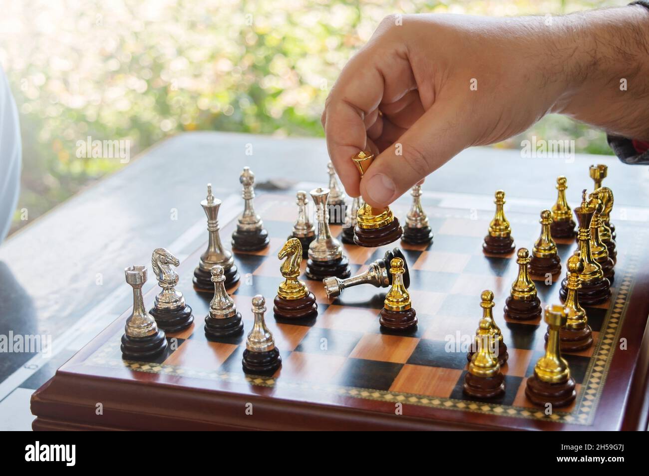 Premium Photo  The silver horse, knight chess piece standing with falling  golden queen, rook, bishop, pawn pieces on chessboard on dark, vertical.  leadership, winner, competition, and business strategy concept.