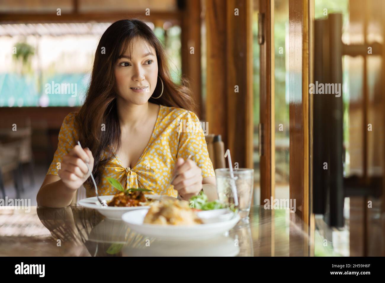 young woman eating spaghetti food in restaurant Stock Photo
