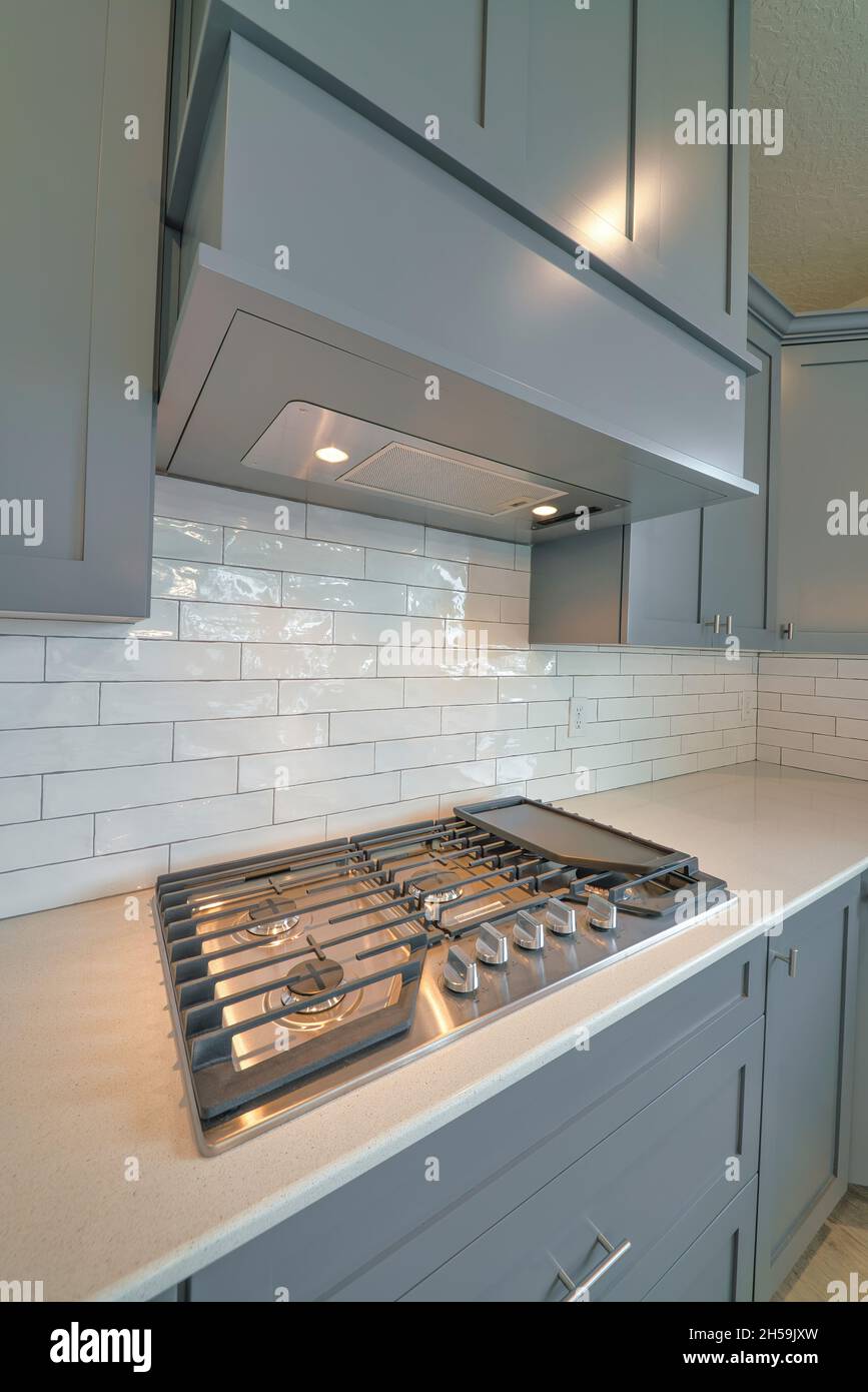 Residential kitchen interior with cooktop stove on countertop under