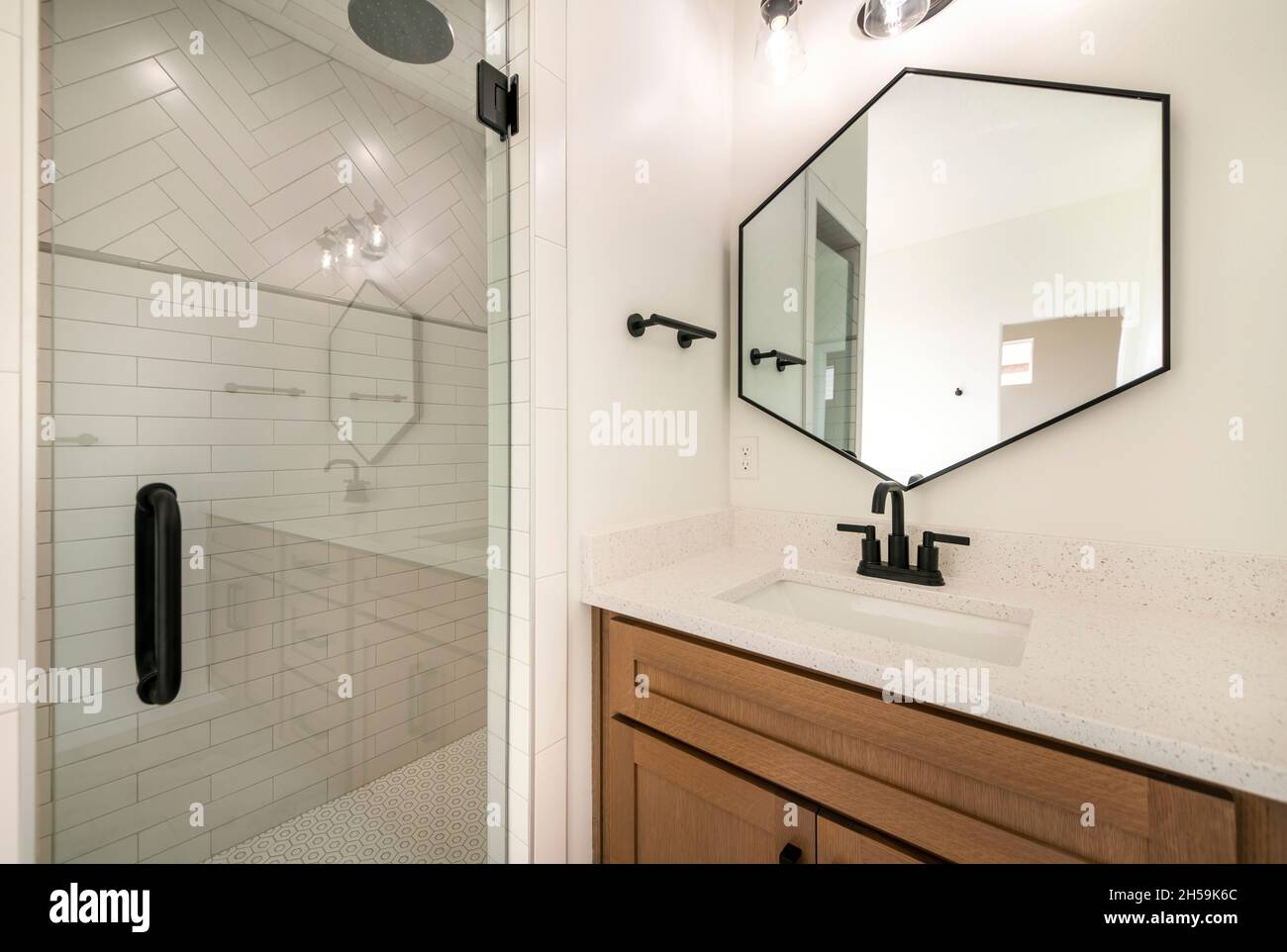Interior of a bathroom with same fixtures of shower and vanity sink
