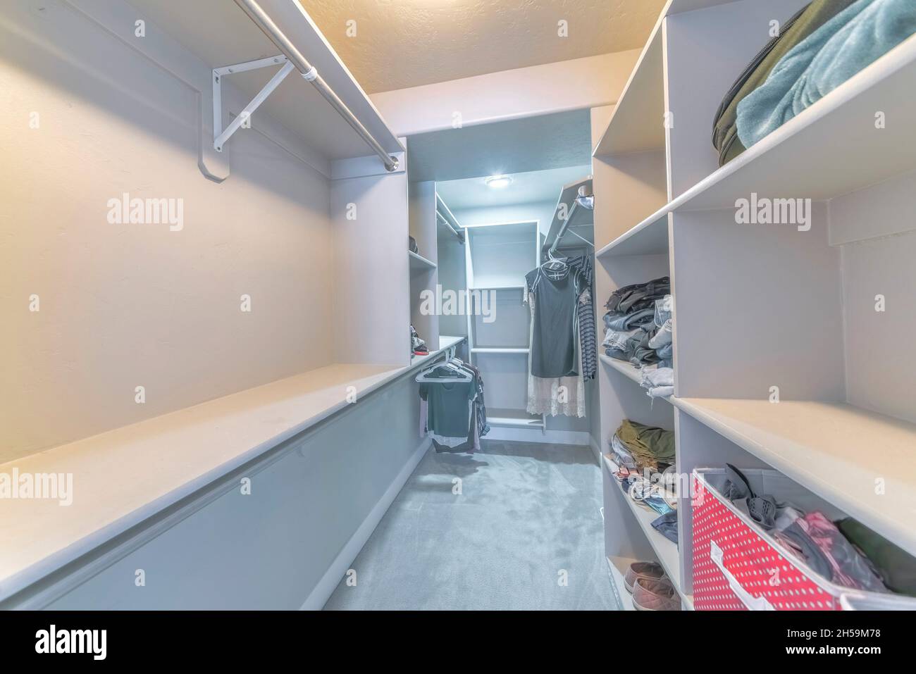 Narrow walkin closet interior with open shelving unit Stock Photo Alamy