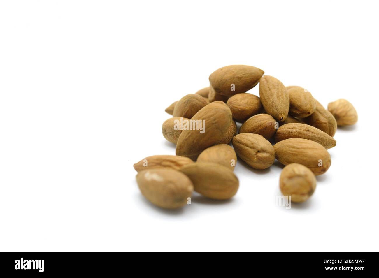 Raw organic healthy almonds on horizontal white backdrop Stock Photo