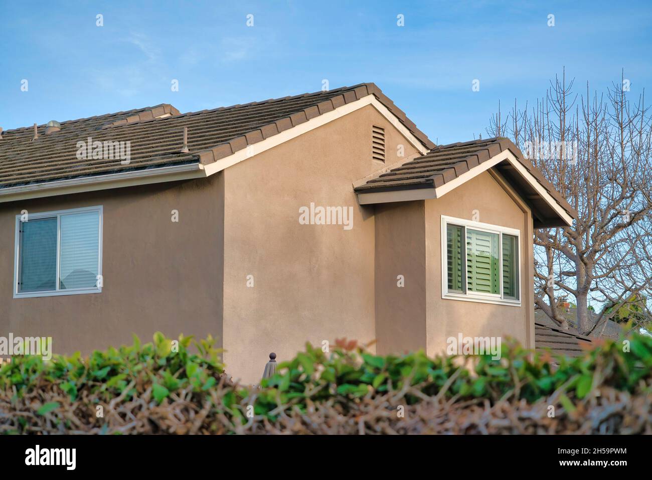 Second floor exterior of a house with light brown siding and bricks roof at  Southern California Stock Photo - Alamy