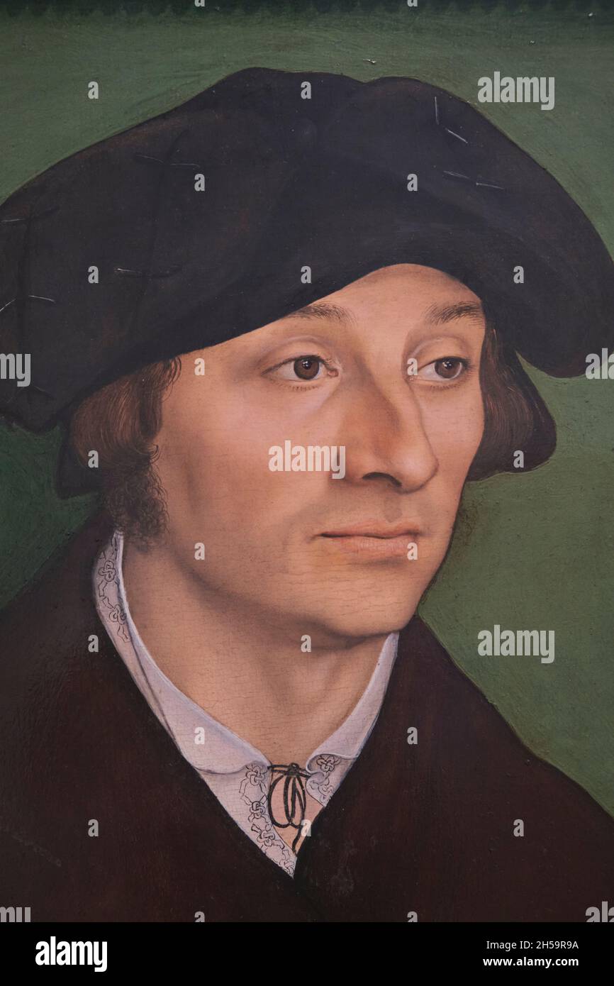 An oil painting on panel with green background titled Portrait of a Man by the German artist Lucas Cranach The Elder. At the National Gallery of Art i Stock Photo