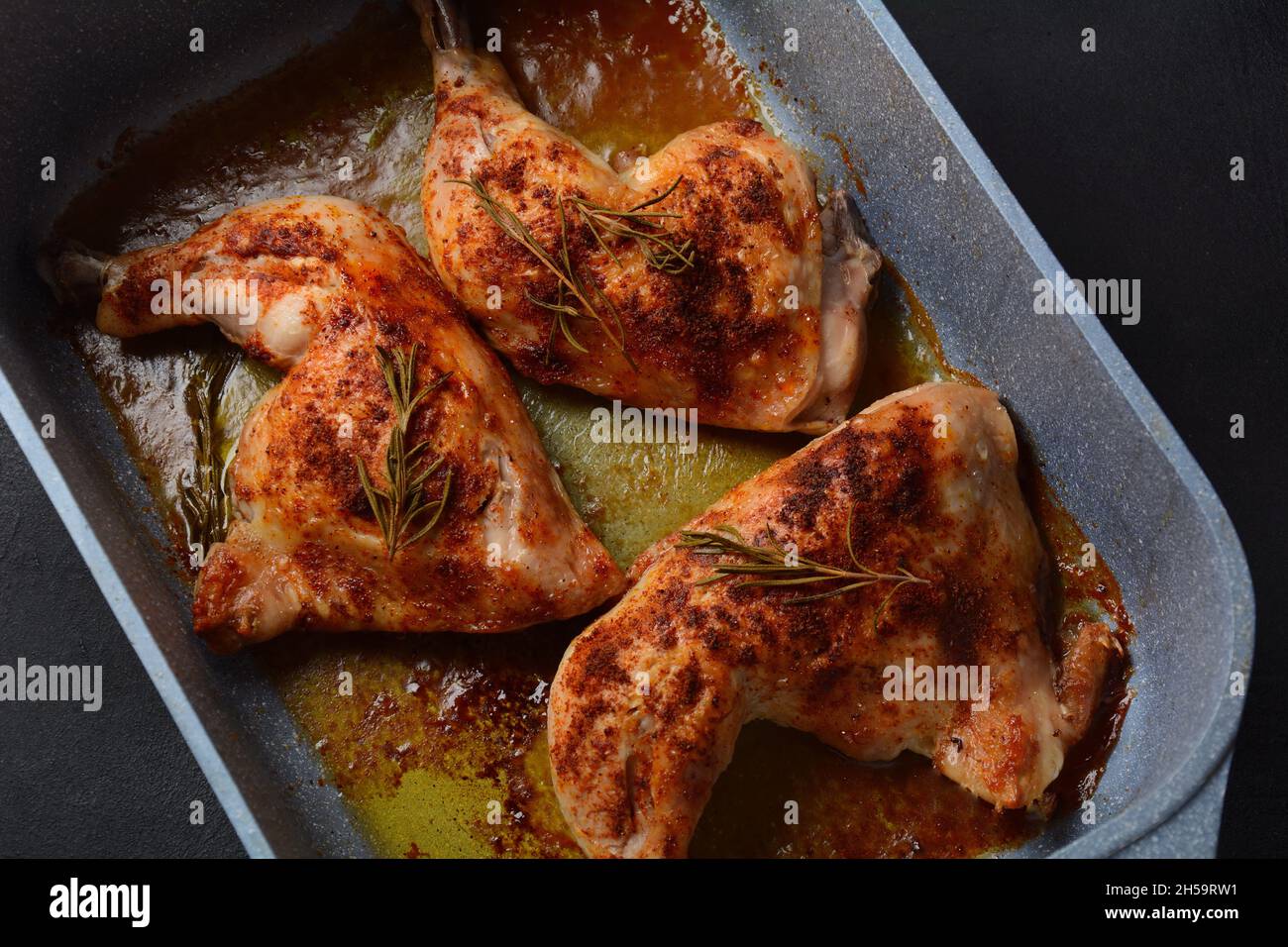 Baked chicken leg quarters and drumsticks seasoned with garlic and