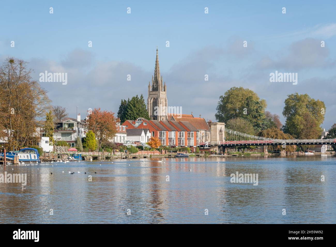All Saint's Church and Marlow suspension bridge next to the River Thames at Marlow, Buckinghamshire, England. Stock Photo