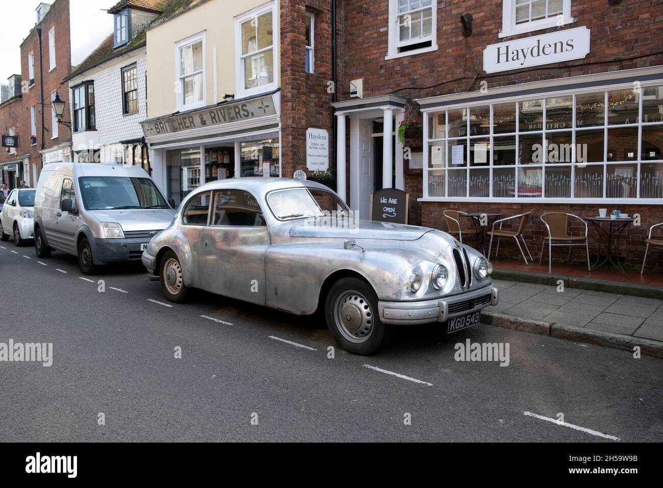 Silver classic vintage Bristol 403 1950s car parked outside shops in
