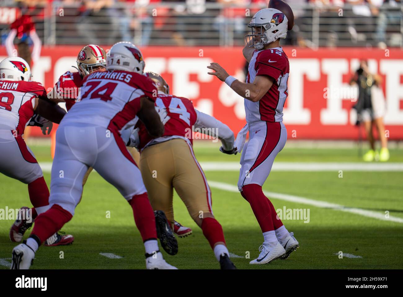 Arizona Cardinals quarterback Colt McCoy (12) passes the football while being pressured by San Francisco 49ers defensive lineman Jordan Willis (94) du Stock Photo