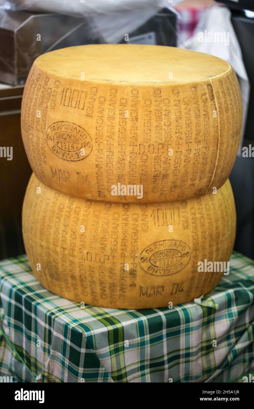 Italian parmesan cheese wheels stacked on the marketplace Stock Photo