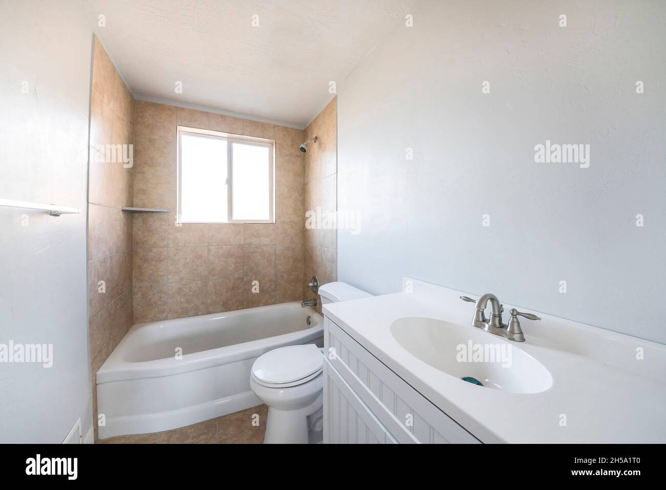 Interior of a bathroom with window on top of a bathtub Stock Photo