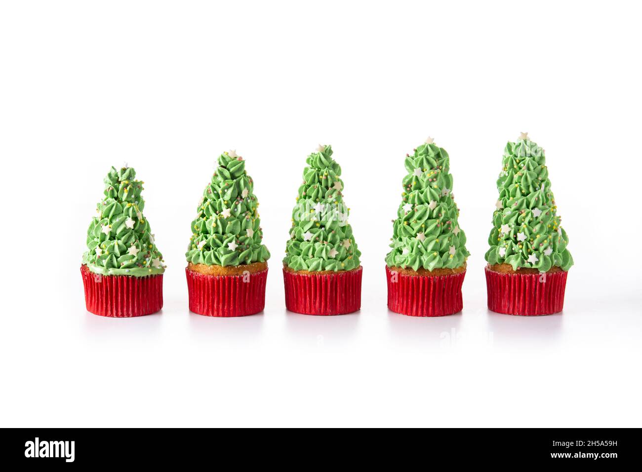 Christmas tree cupcakes isolated on white background Stock Photo