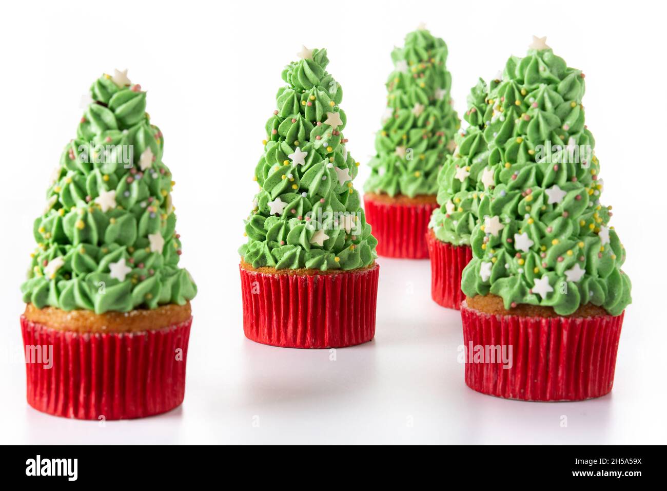 Christmas tree cupcakes isolated on white background Stock Photo