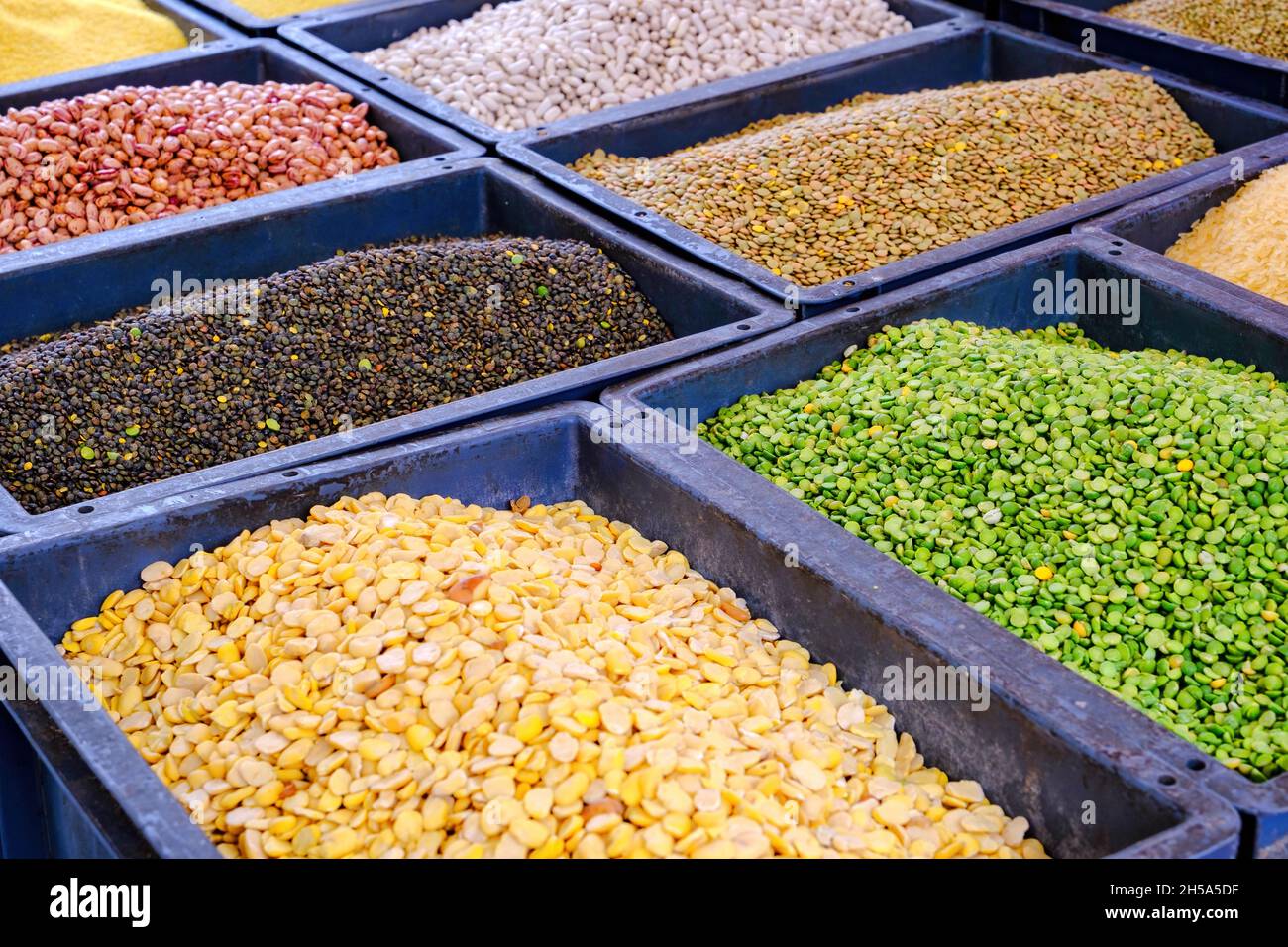 many assorted beans on the market - green, yellow, white, black Stock Photo