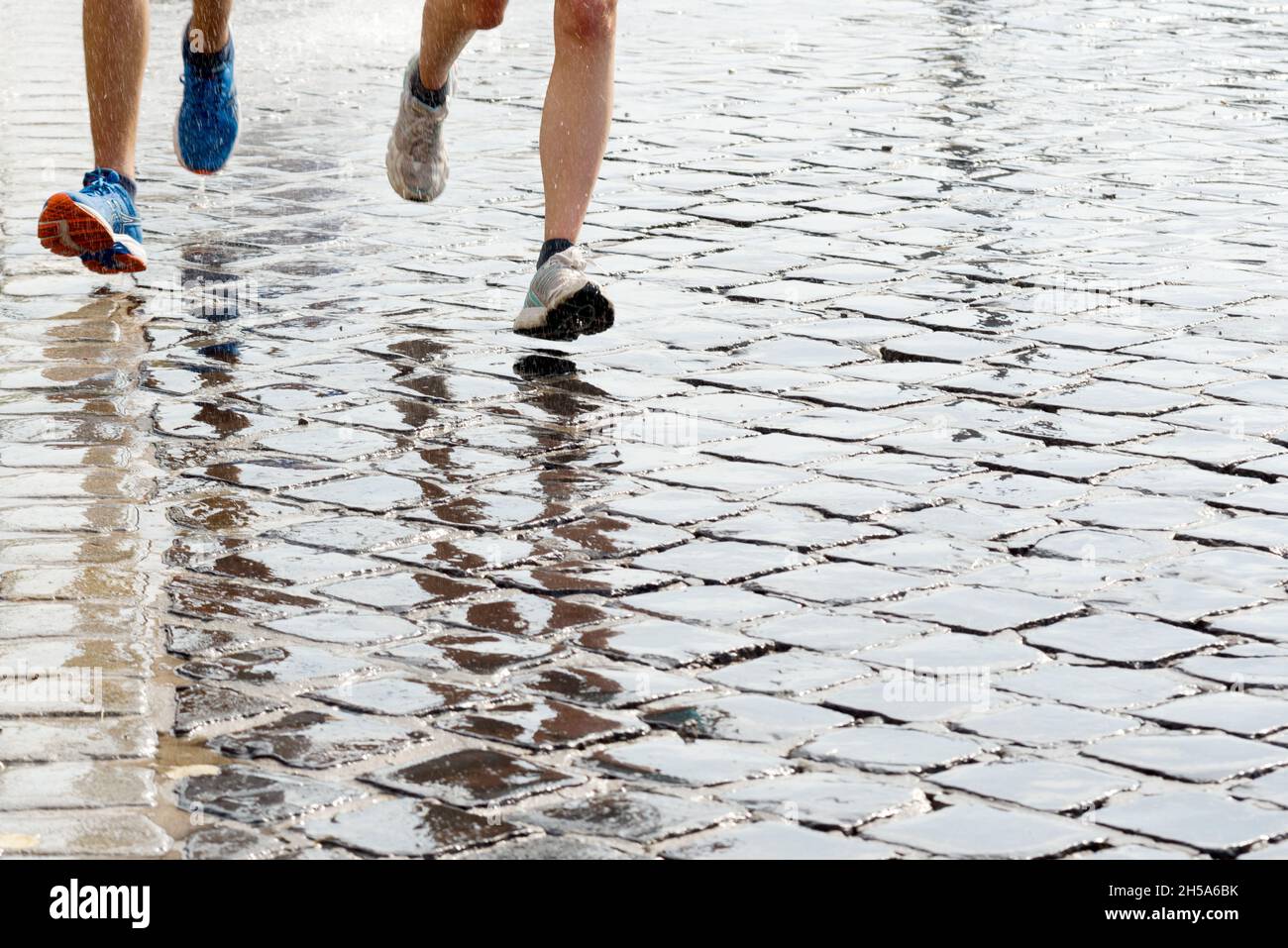 Feet of teenagers running on a wet pavement Stock Photo Alamy