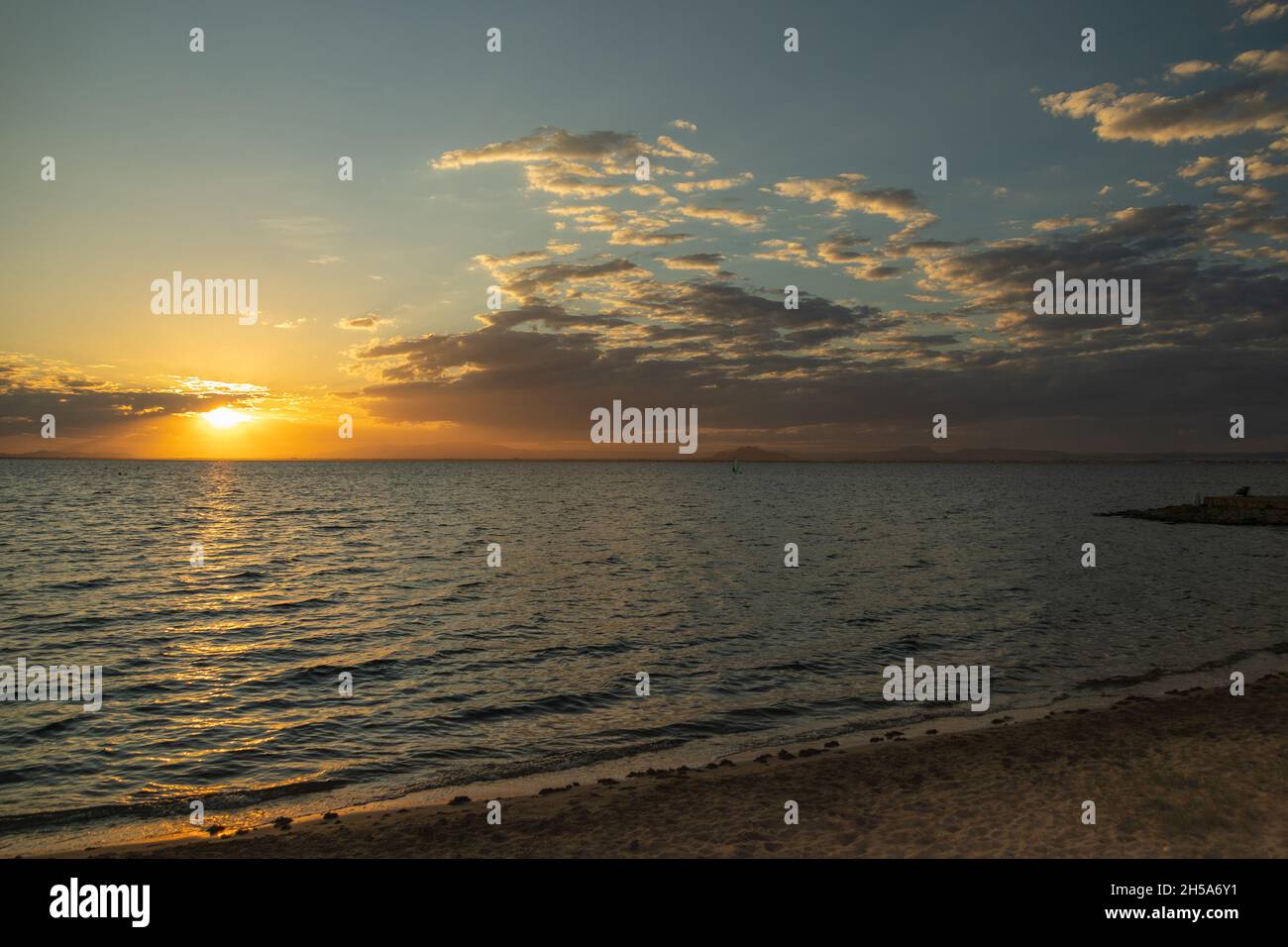 Beautiful scenery of the sea under a sunset sky Stock Photo - Alamy