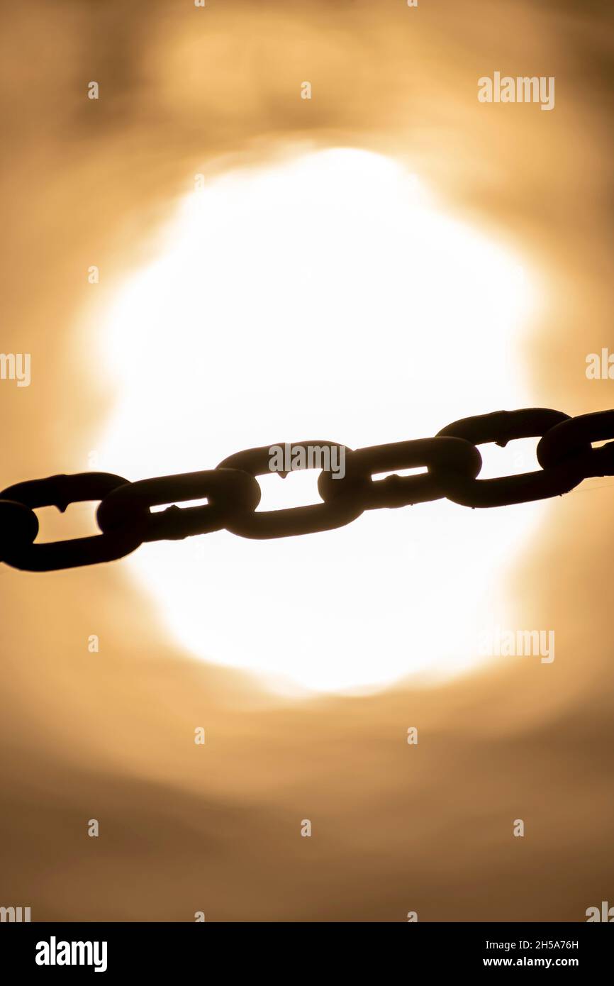Chain across sun reflection in the water Stock Photo - Alamy