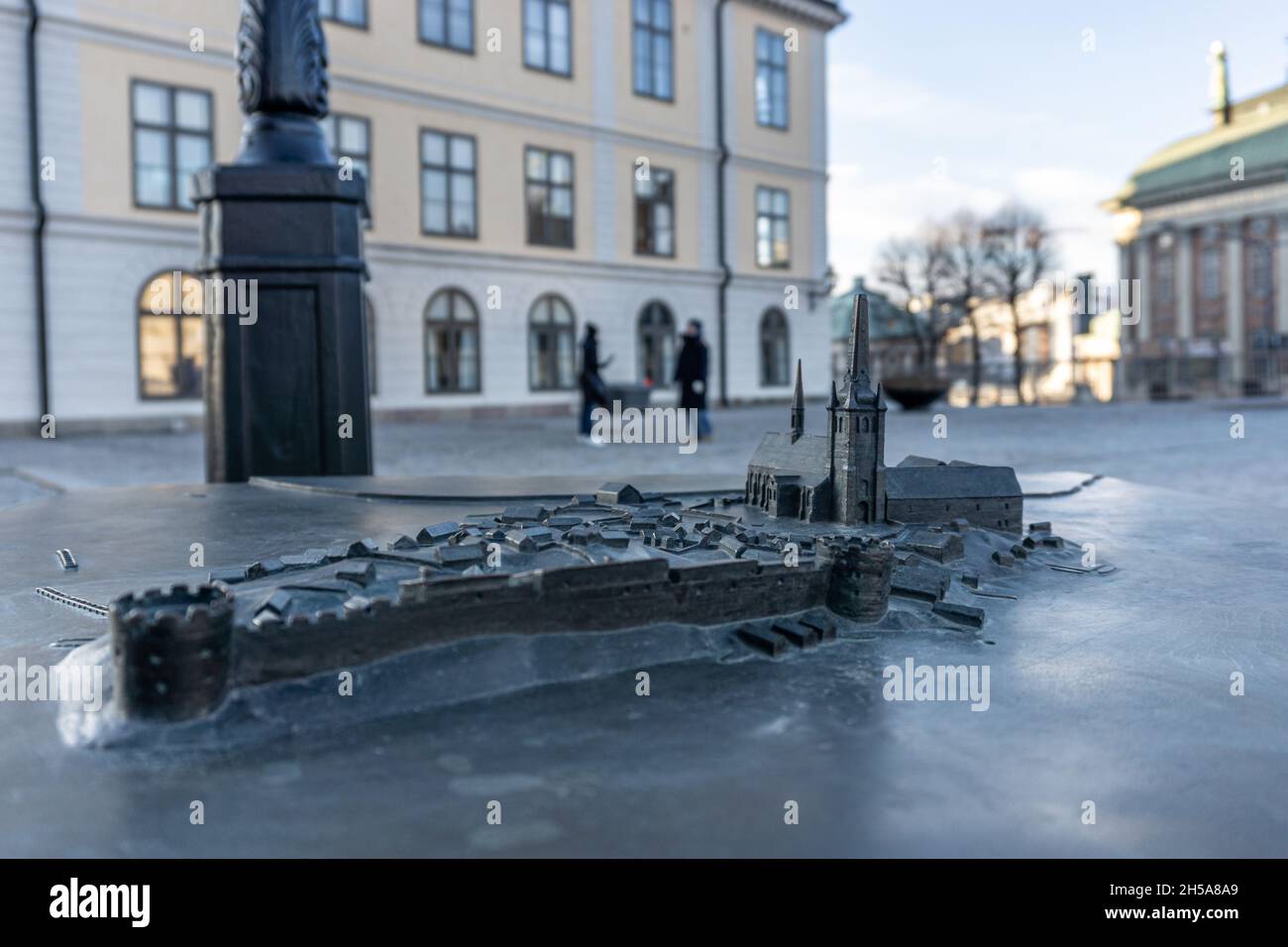Stockholm, Sweden - April 5, 2021: View onto bronze plate with miniature model of building with blurred background with two people Stock Photo