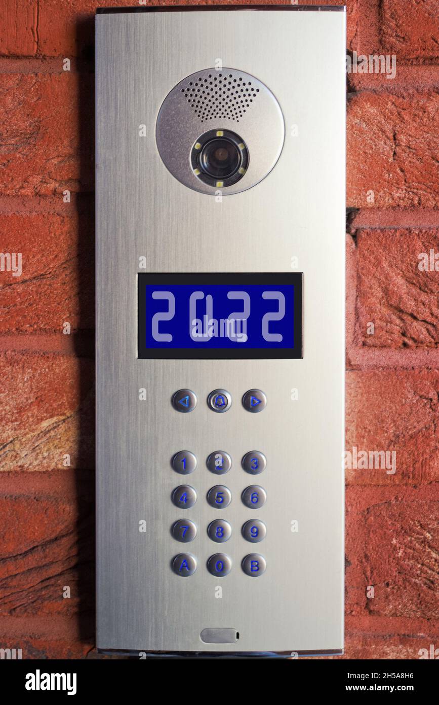 2022 number on the screen of the intercom, video and voice security system on entrance to the house in winter holidays eve. Protection and security Stock Photo
