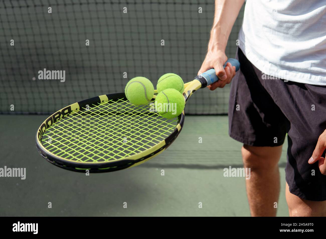 close-up. male hands holding tennis racket and balls. bali Stock Photo