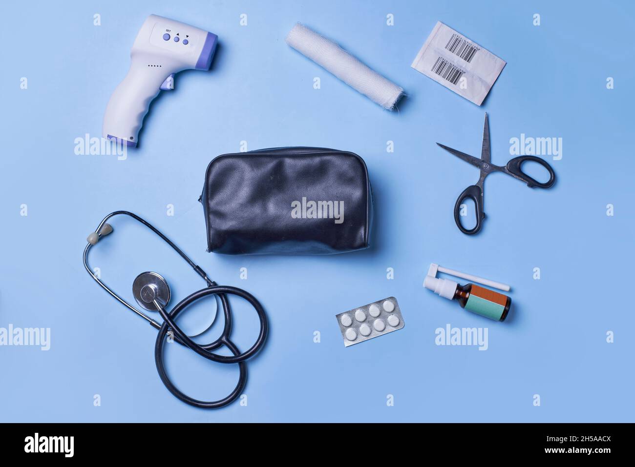 Medical background with various items on blue background. First aid kit ...