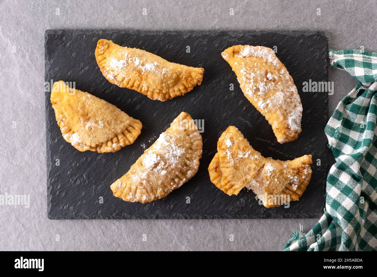 Spanish sweet stuffed pastry filled with angel hair on wooden table Stock Photo