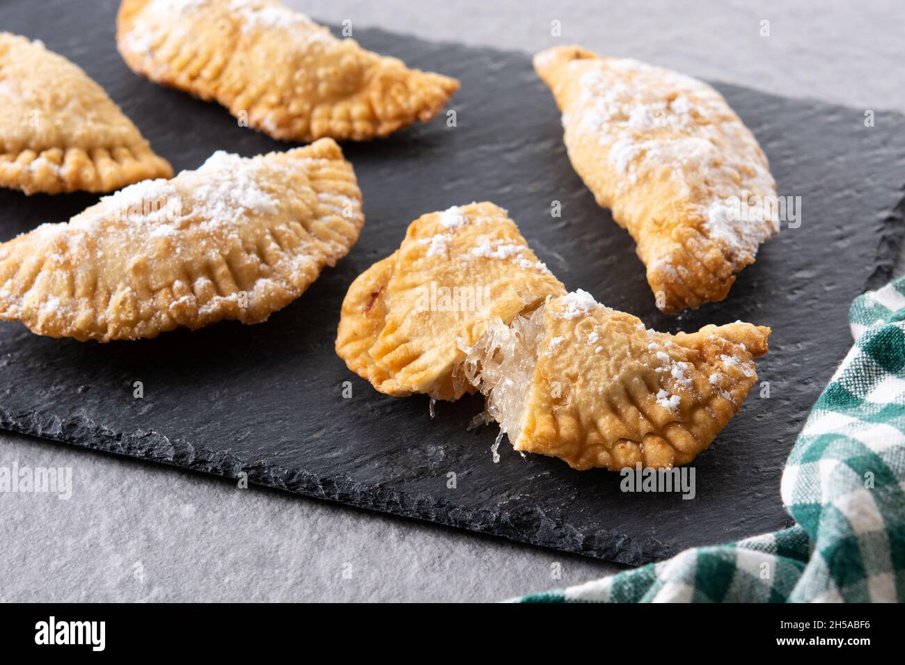Spanish sweet stuffed pastry filled with angel hair on wooden table ...
