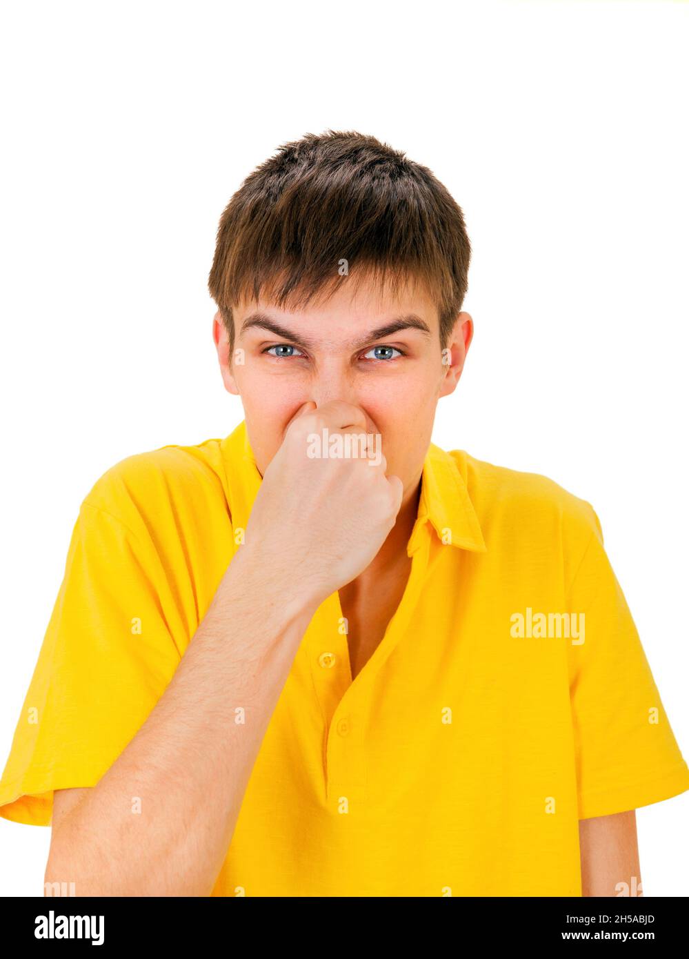 Displeased Young Man close the Nose Isolated on the White Background Stock Photo