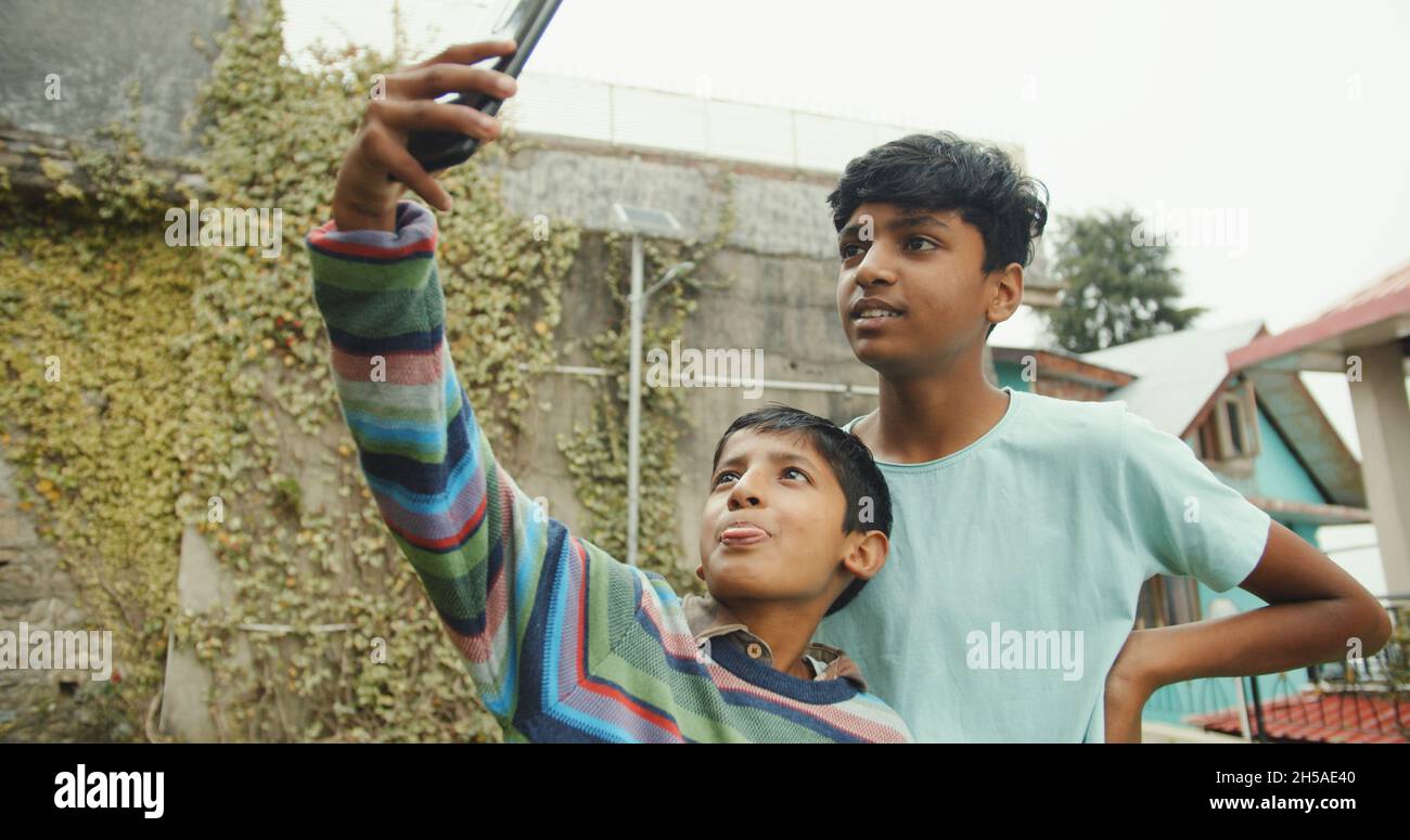 Little brothers from India taking a selfie in Shimla, Himachal Pradesh