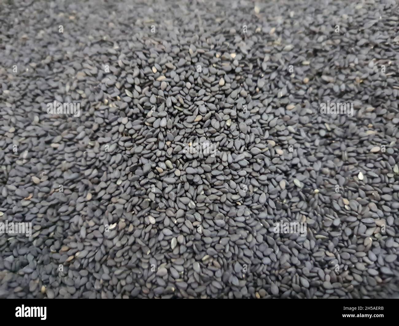 Black sesame seeds (Sesamum indicum). Top view, backgrounds and textures. Stock Photo