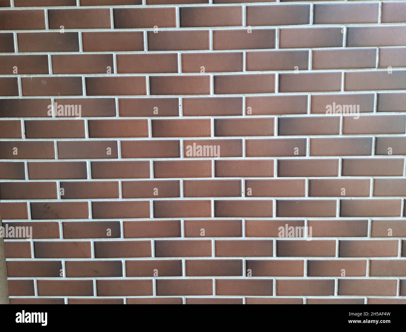 Seamless vintage style design on cream beige yellow brown brick wall ,background texture. Full screen. Stock Photo