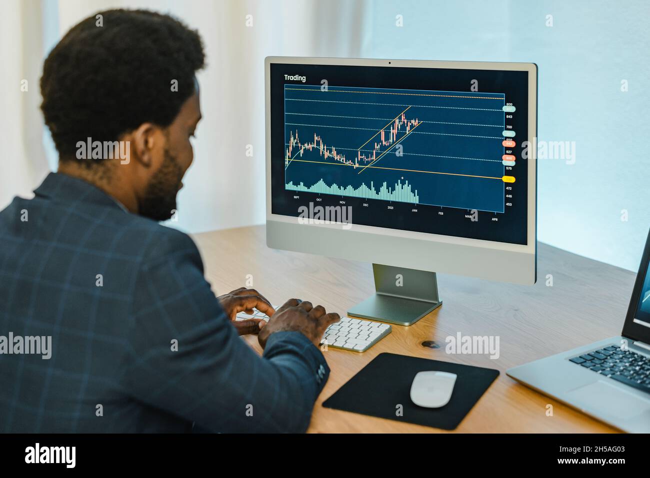 Black male trader typing on keyboard Stock Photo