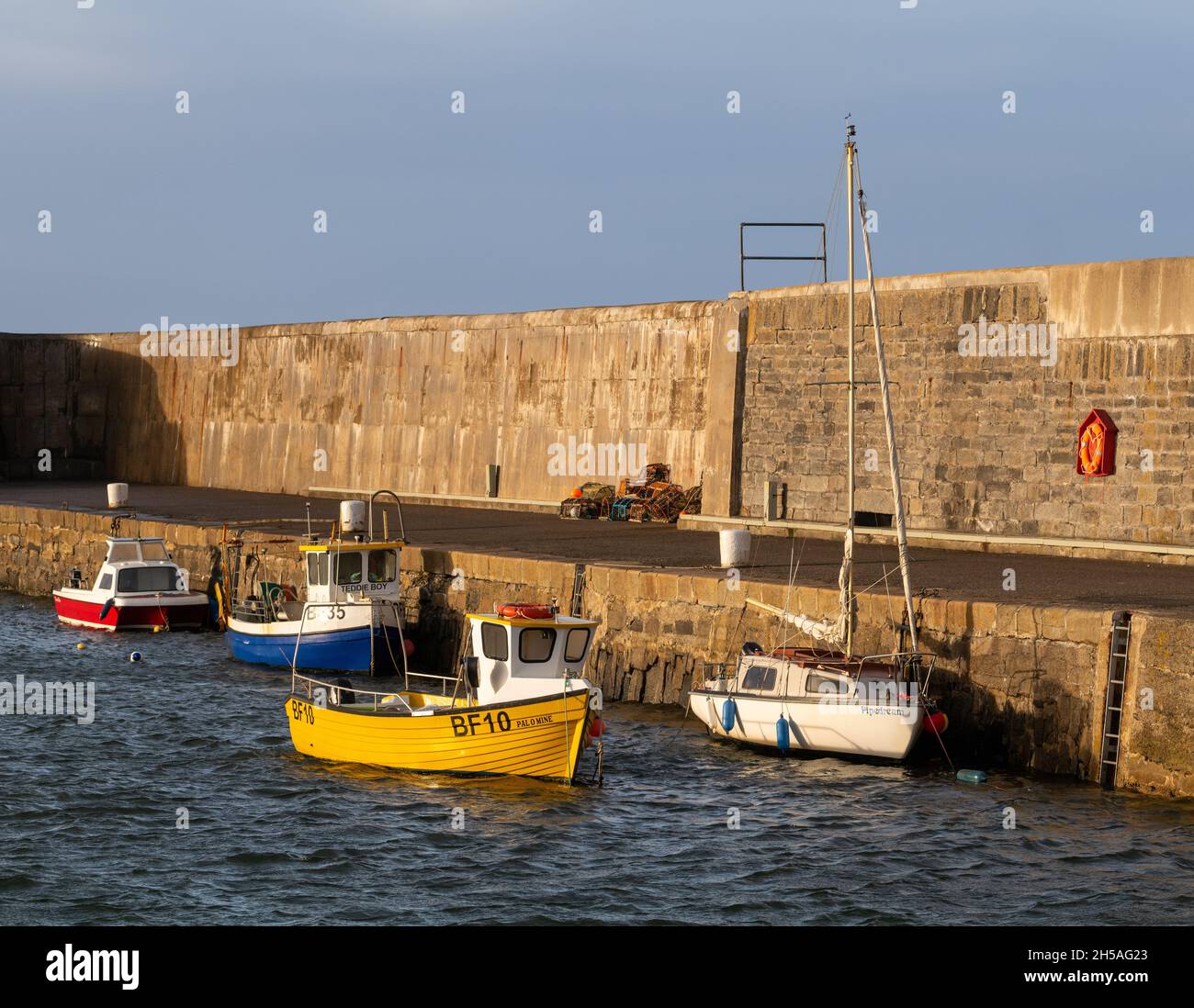 PORTSOY, ABERDEENSHIRE, SCOTLAND - 7 NOVEMBER 2021: This is a small creel fishing boat called Pal O Mine which is Friend Of Mine at Portsoy Harbour, A Stock Photo