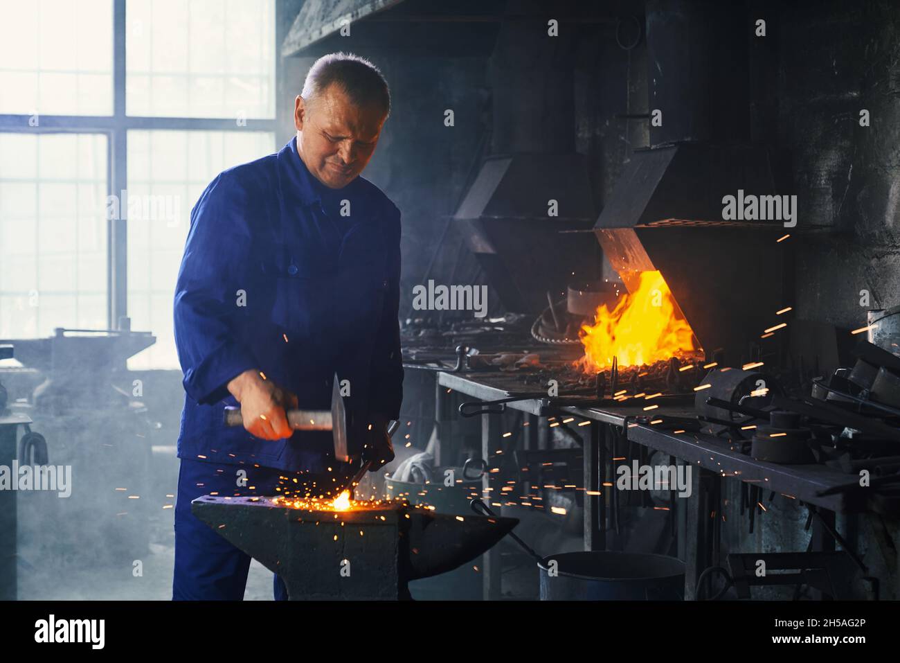 Blacksmith manually forging molten metal hi-res stock photography and ...
