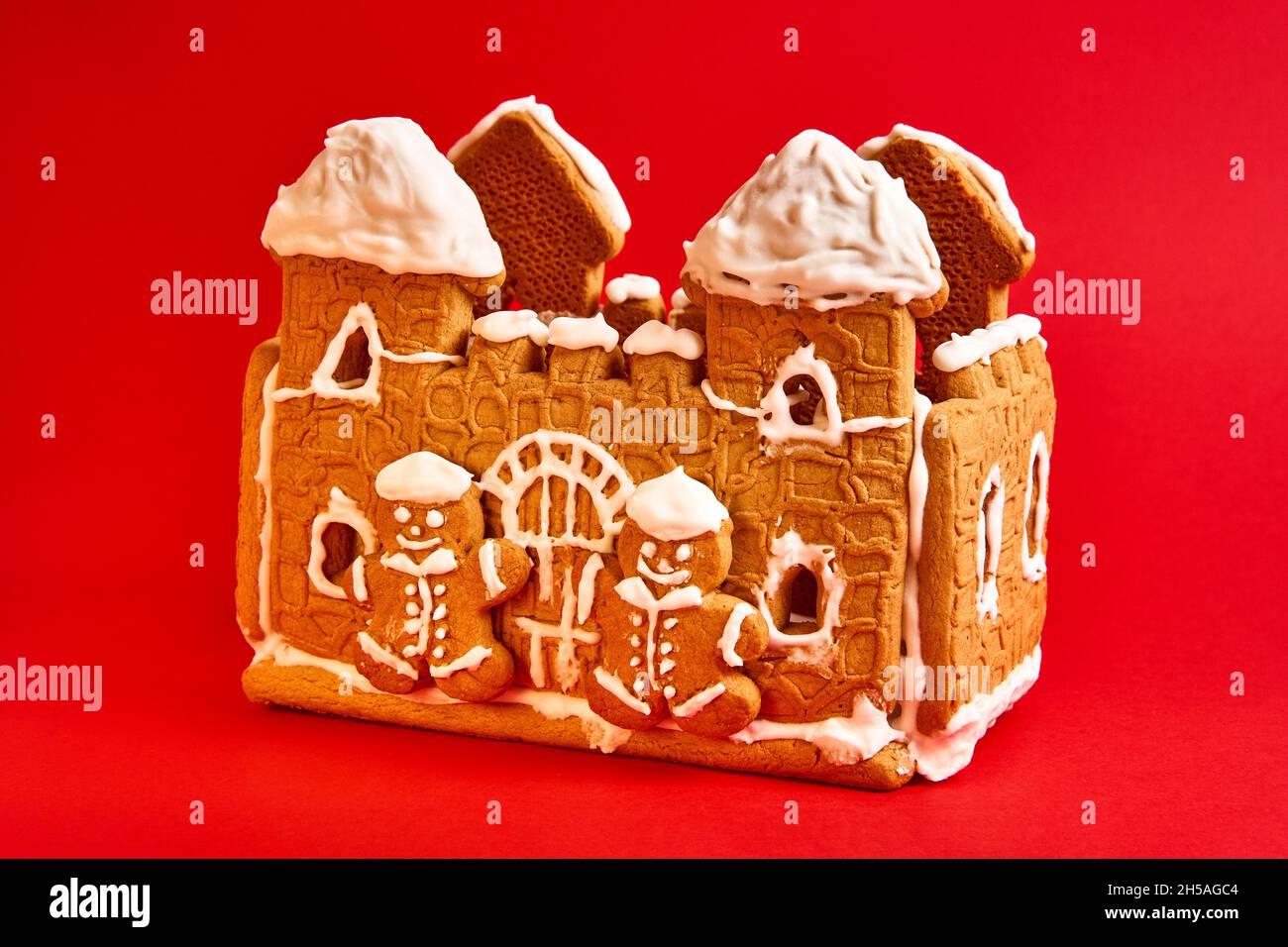 gingerbread house with icing decor on red background Stock Photo - Alamy