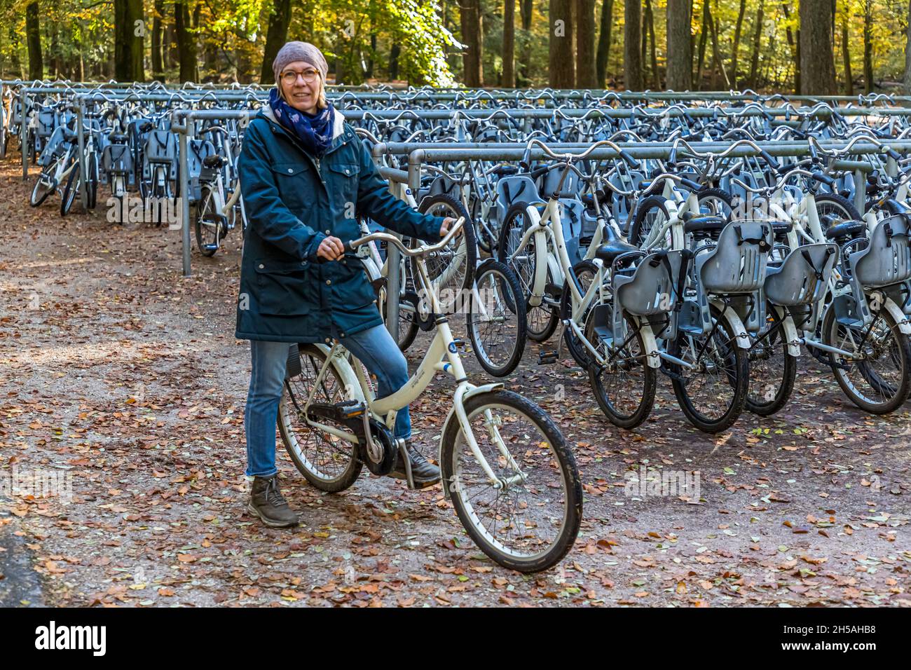 Bike station with free white bikes in the Nationalpark De Hoge Veluwe in Hoenderloo, Netherlands Stock Photo