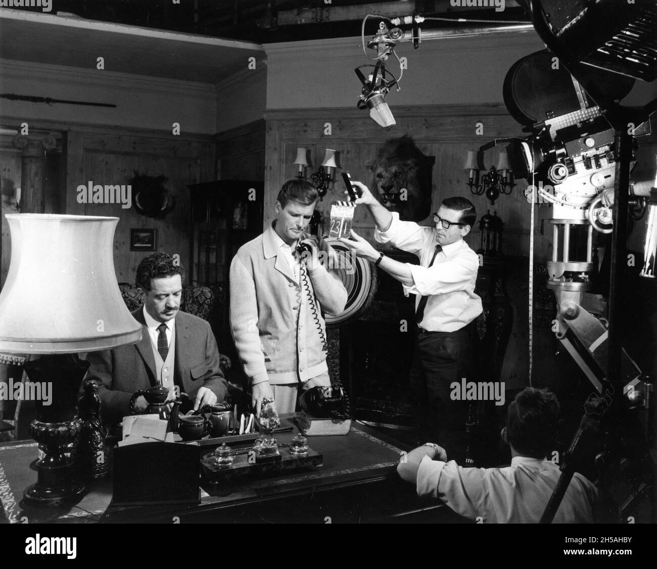 JOHN GREGSON as Colonel Roberts and ROGER MOORE as Simon Templar on set candid at Associated British Elstree Studios during filming of THE SAINT episode ESCAPE ROUTE aired December 30th 1966 Season 5 Episode 13 director ROGER MOORE writer Leslie Charteris screenplay Michael Winder music Edwin Astley producer Robert S. Baker Bamore / Incorporated Television Company (ITC) Stock Photo