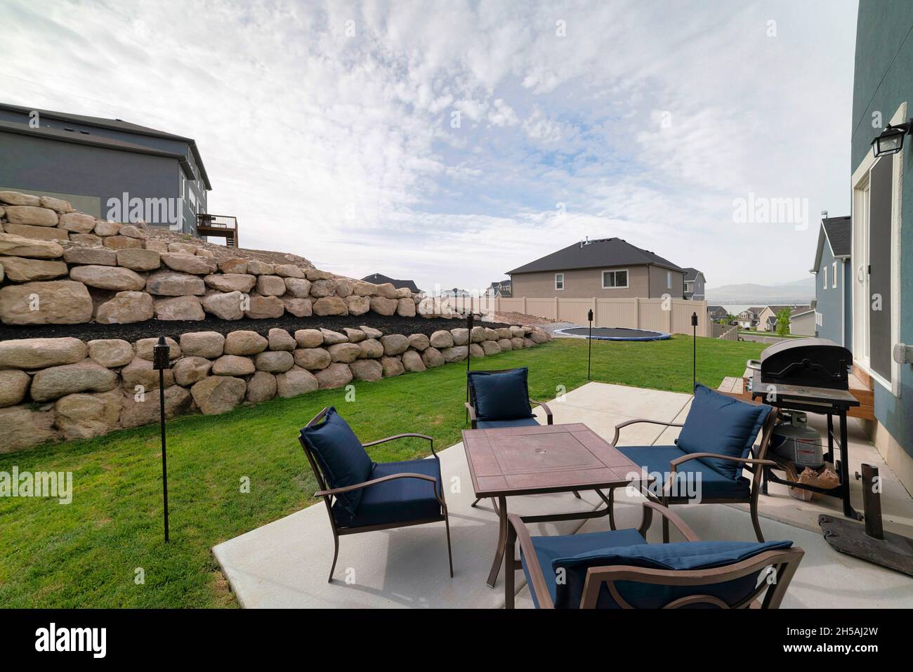 Outdoor patio with lounge chairs and barbecue gas griller Stock Photo