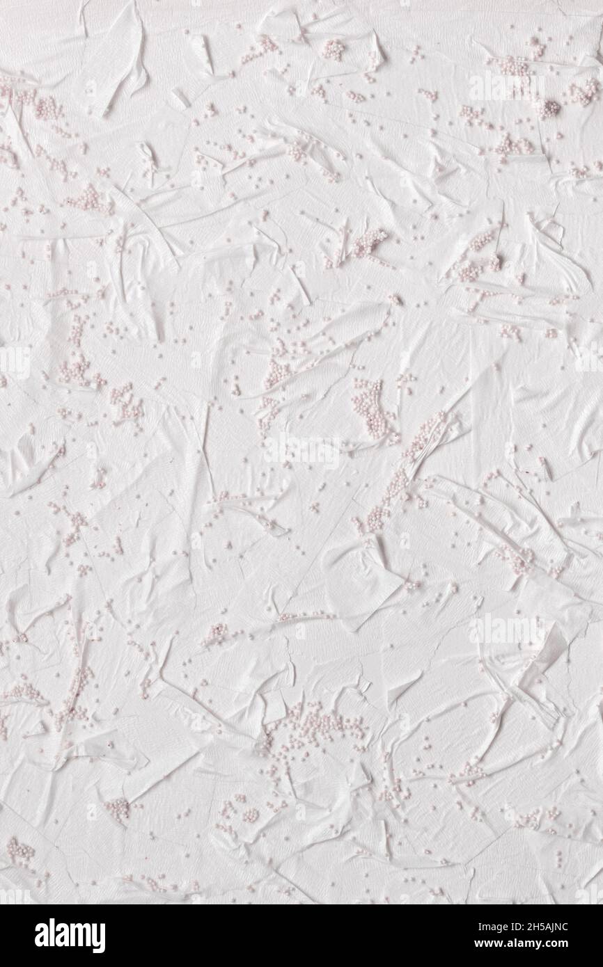 Textured handmade paper with pieces of adhesive tape and beads