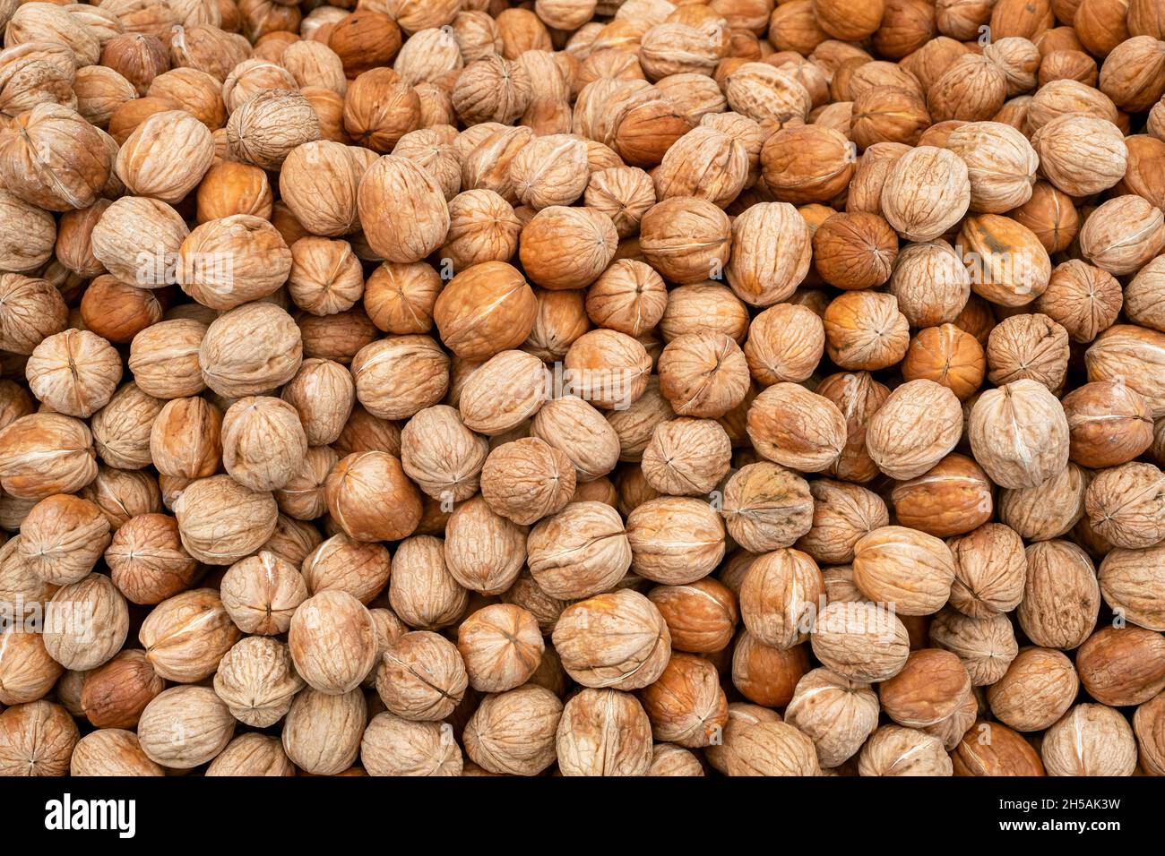 Pile of natural walnuts at a street market. Heap of walnut as