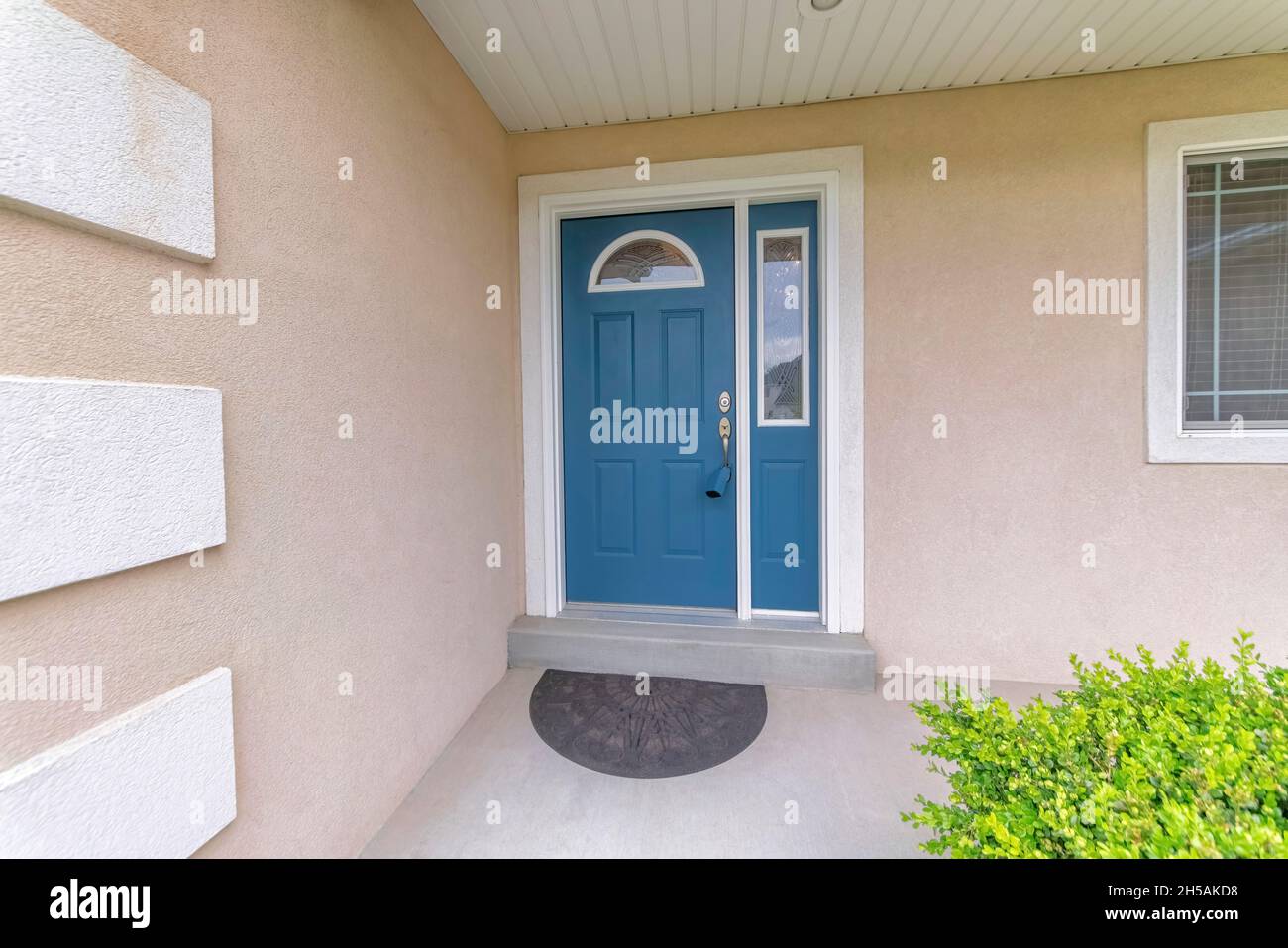 Blue front door exterior with blue lockbox on the handle and side panel ...
