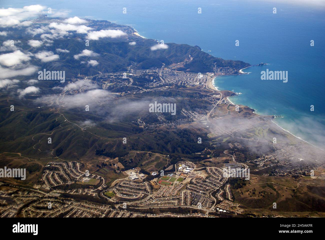 Flying over the San Francisco Peninsula: the Pacific coast and the coastal suburb of Pacifica. Stock Photo