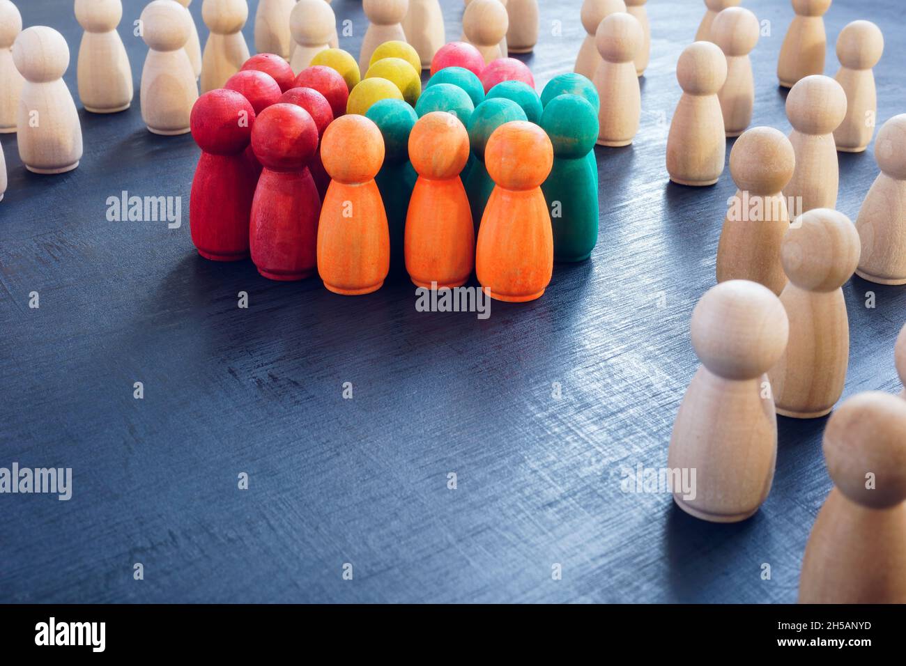 Inclusion concept. Group of color figures and wooden ones Stock Photo ...