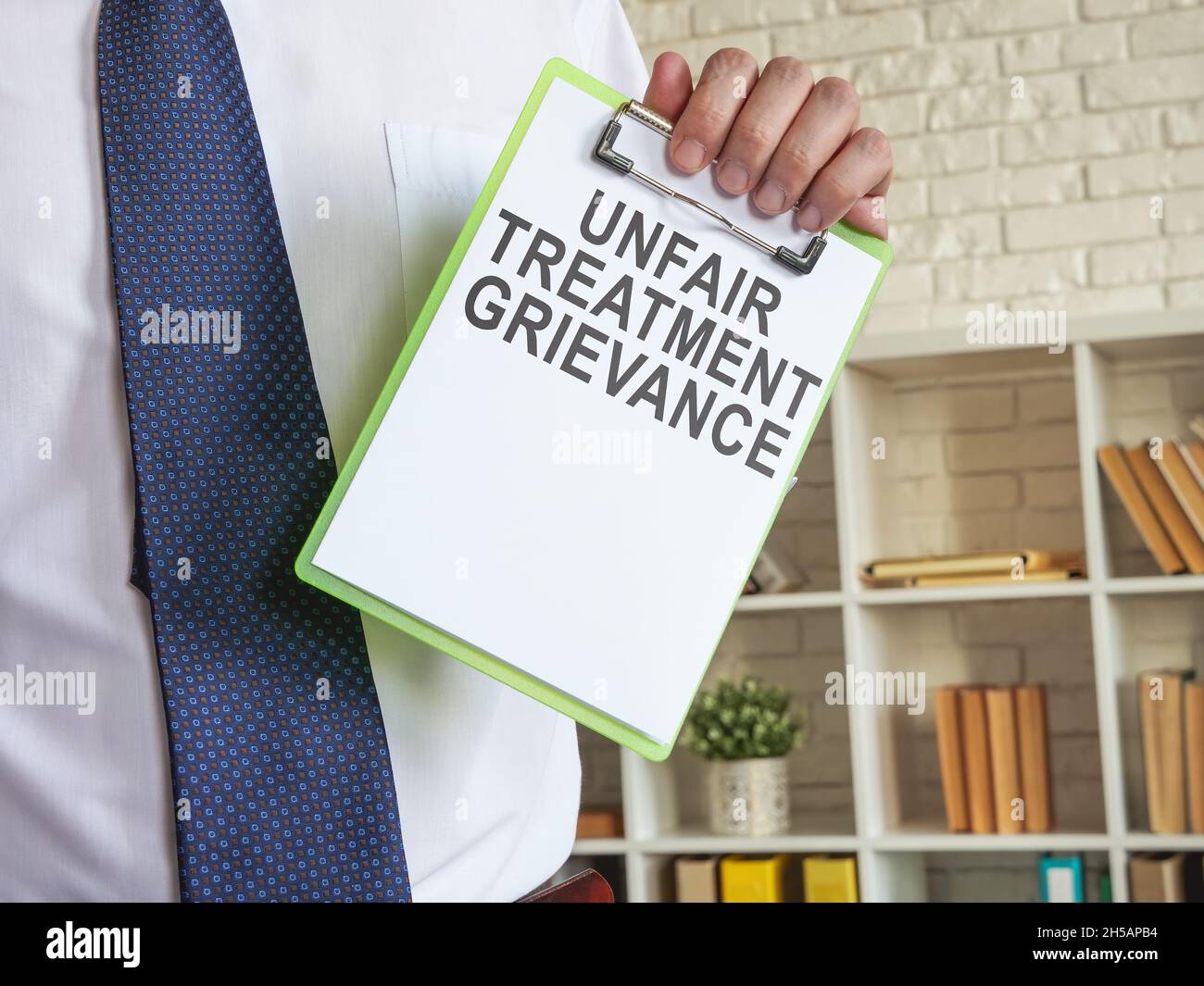 Unfair treatment grievance with clipboard in the hands. Stock Photo