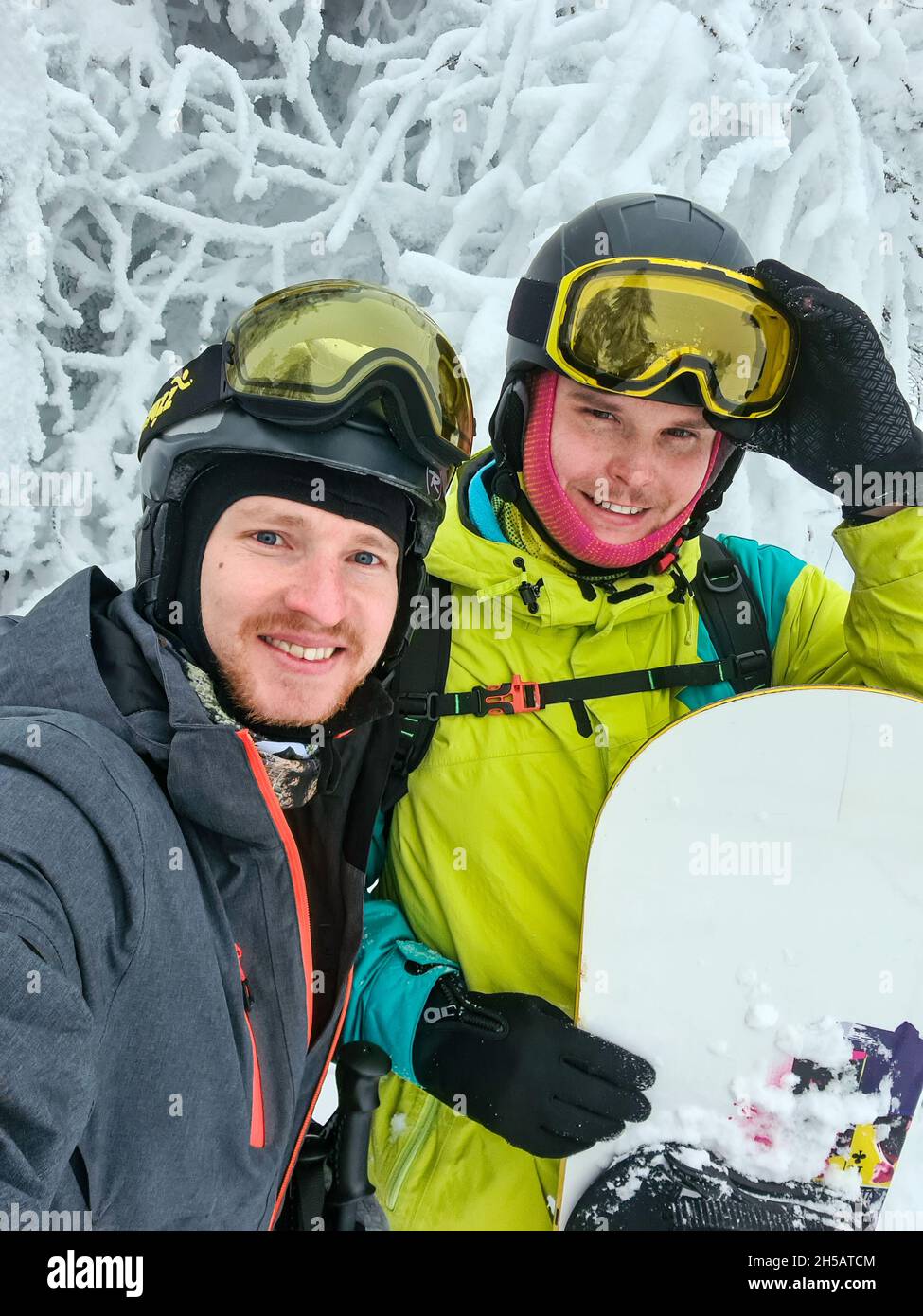 friends taking selfie at the slope snowboarding and skiing concept ...